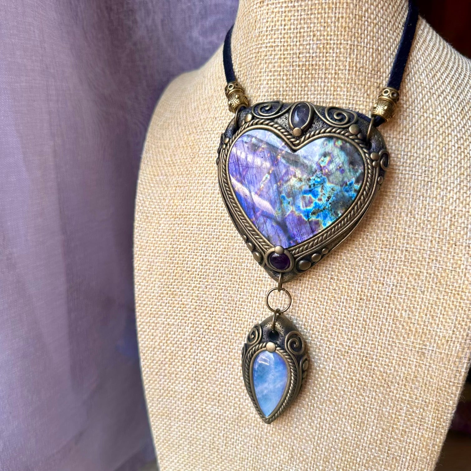 Handmade statement crystal necklace featuring a Large Purple Labradorite Heart with Rainbow Moonstone, Clear Topaz and Amethyst, a one of a kind crystal talisman designed for intuition, spiritual growth, emotional balance and inner transformation.
