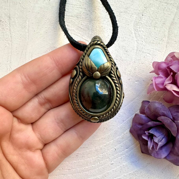 Handmade energy tool necklace with a protective eye-like rainbow sheen Obsidian pendant and ocean-calm Larimar crystal energy.
