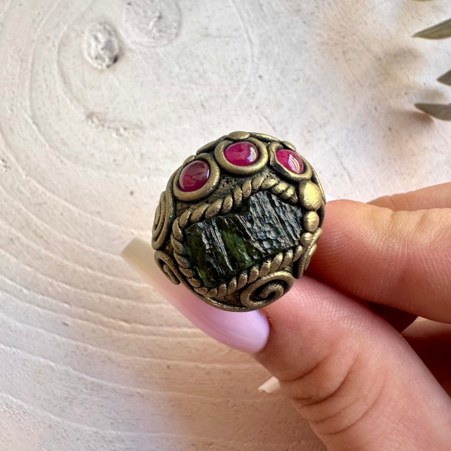 Handmade healing crystal ring featuring Moldavite and natural Rhodolite Garnet.