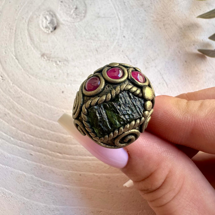 Handmade healing crystal ring featuring Moldavite and natural Rhodolite Garnet.