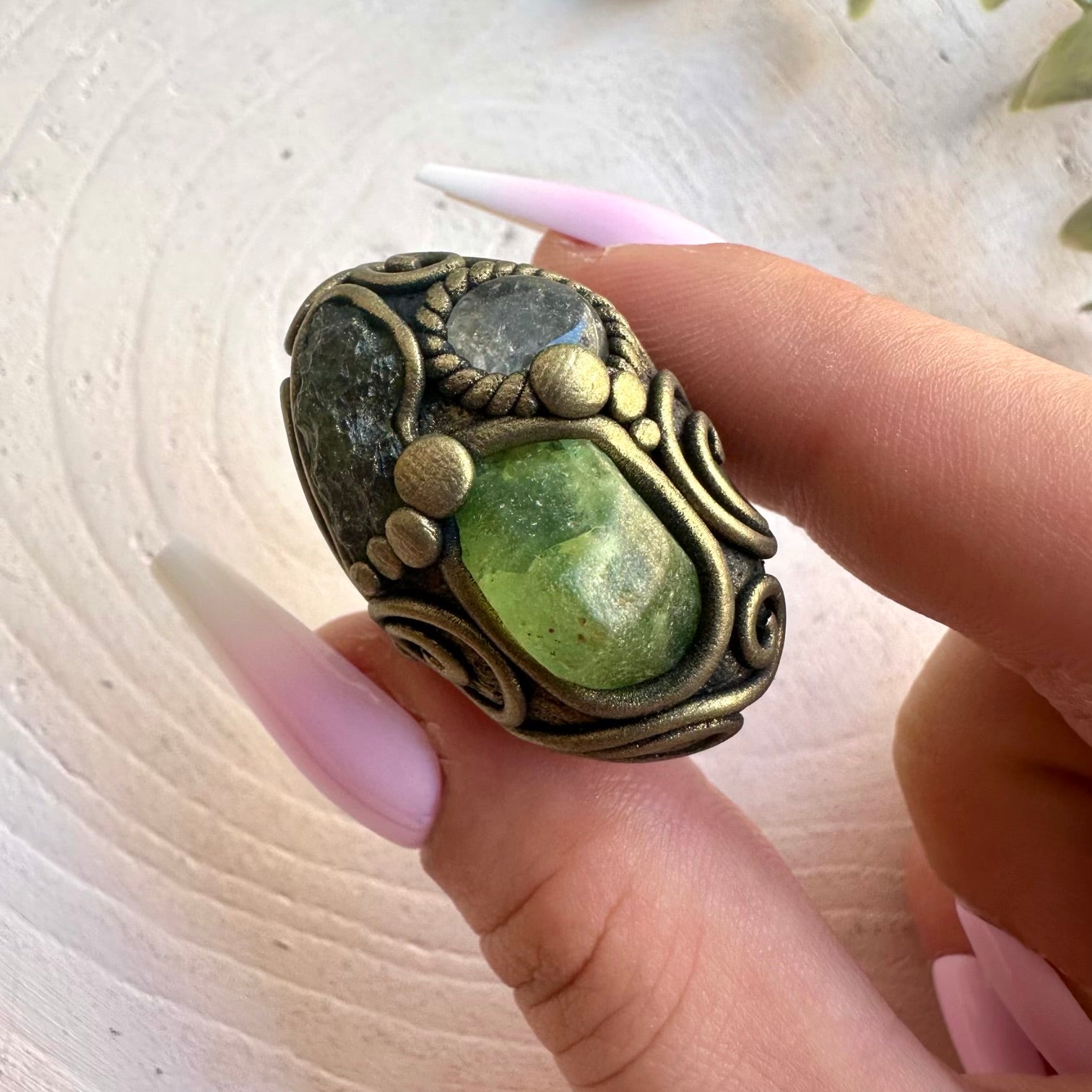 Handmade crystal jewelry showcasing green Moldavite with Peridot and clear Topaz accents.