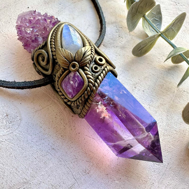 Natural gemstone pendant featuring Amethyst, Rainbow Moonstone and Charoite in an artistic design.