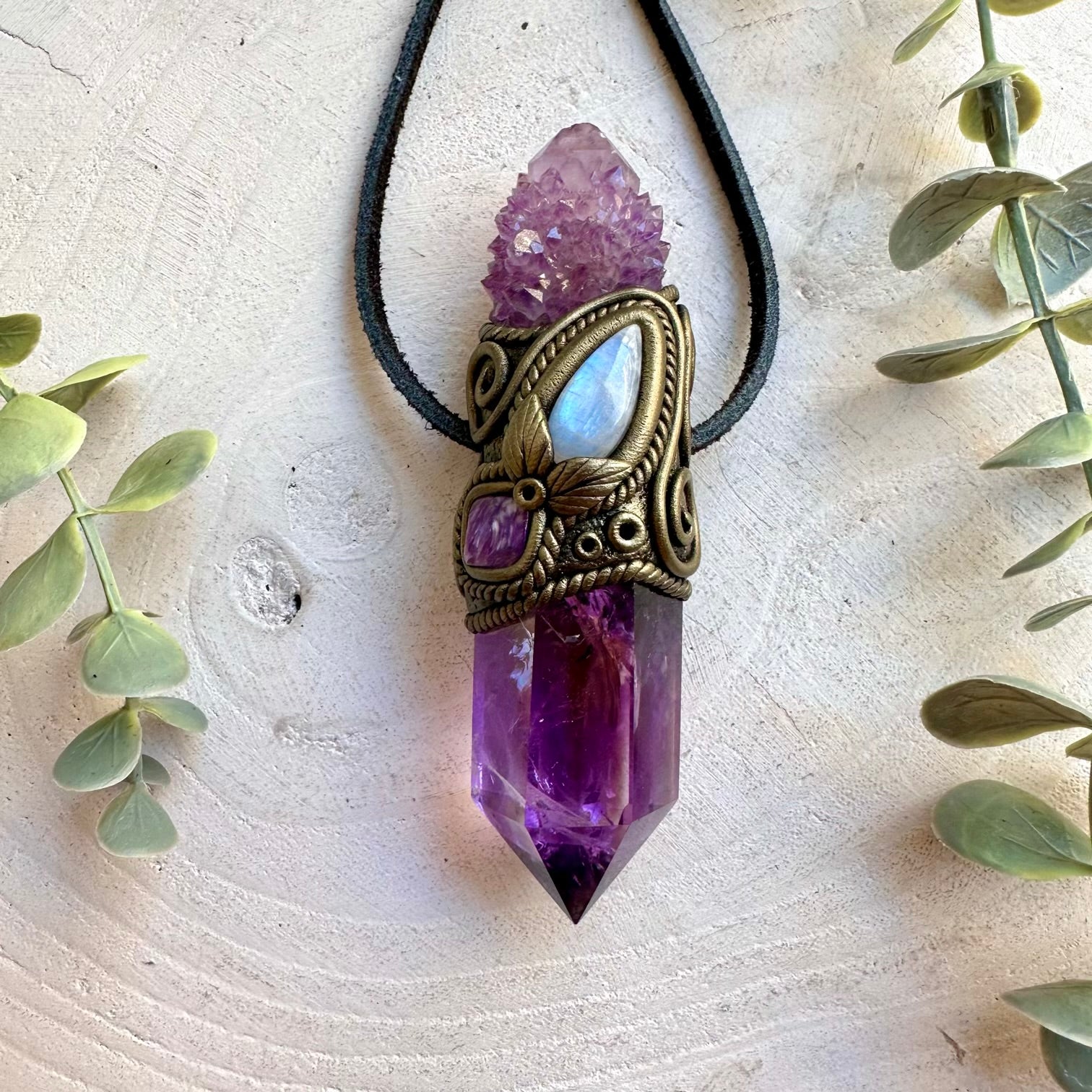 Handmade Amethyst crystal wand and pendant necklace featuring Spirit Quartz, Rainbow Moonstone and Charoite. A one of a kind spiritual energy tool combining purple crystals and shimmering natural gemstones, created for meditation, intention setting, energy work and personal spiritual practice.