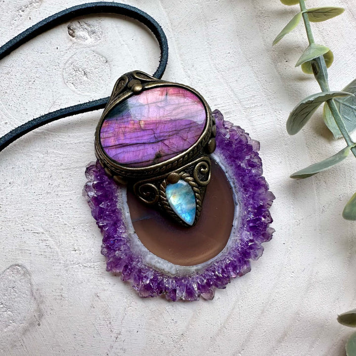 Close up of large amethyst stalactite with pink labradorite and rainbow moonstone