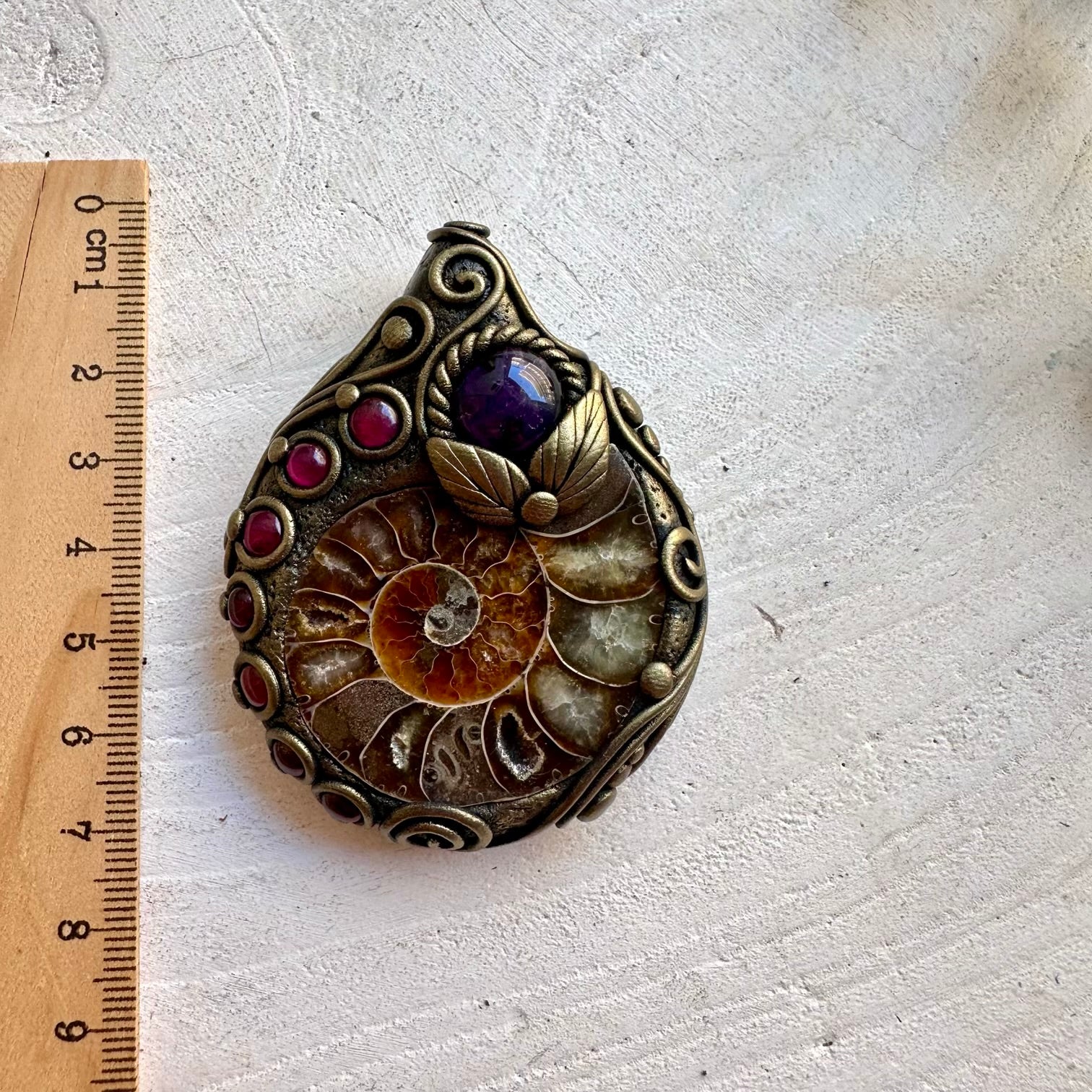 Handmade healing crystal necklace featuring Ammonite, Amethyst and Rhodolite Garnet.