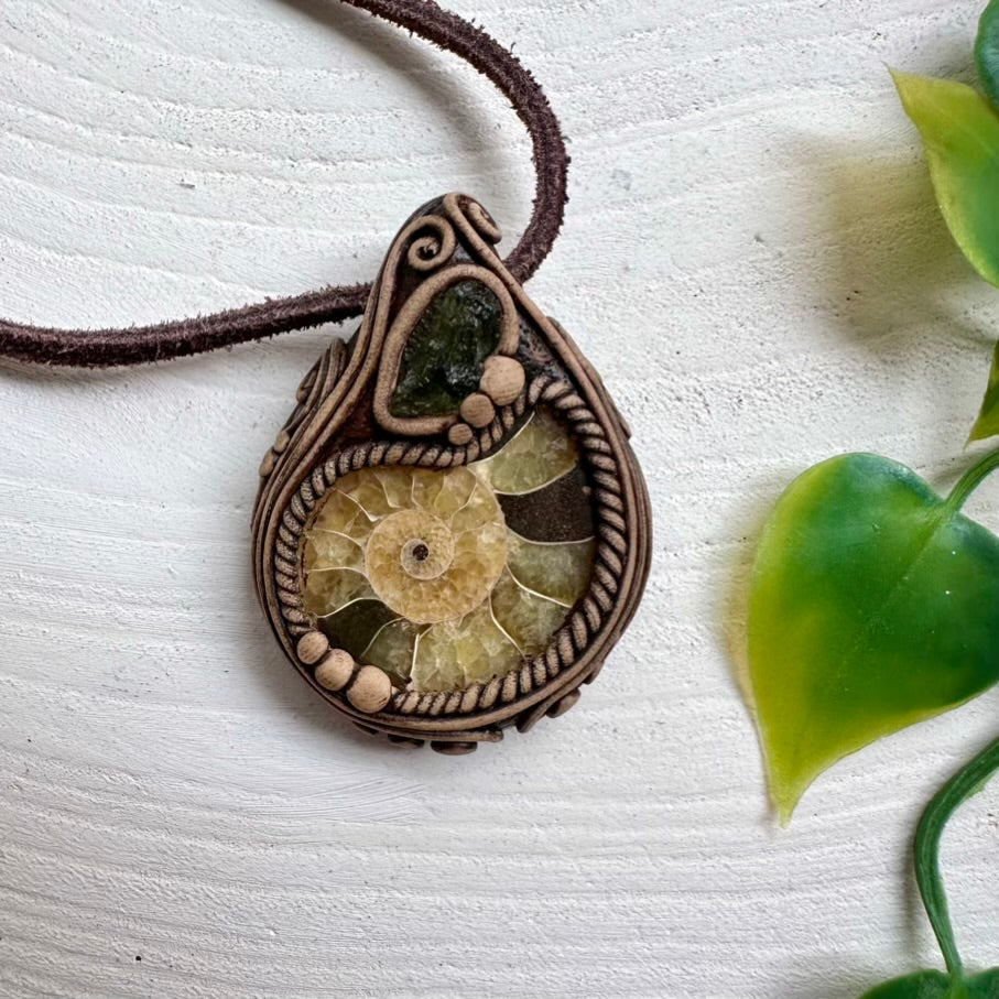 Handcrafted necklace featuring Ammonite fossil and raw Moldavite