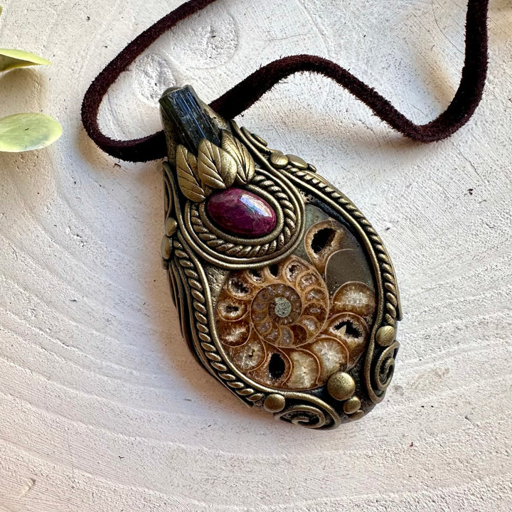Ammonite with Black Tourmaline and Ruby necklace, handcrafted as a unique gemstone pendant.