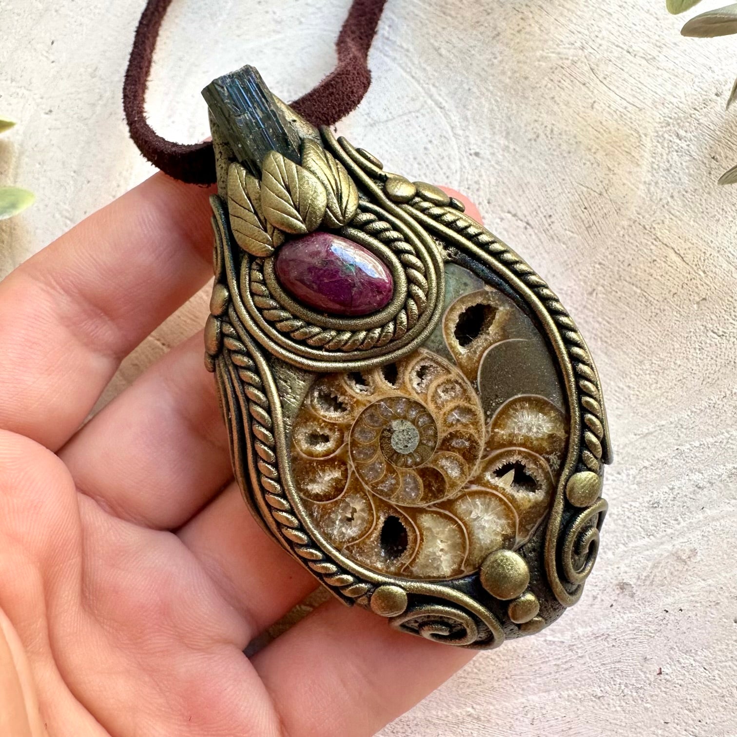 Handmade pendant combining an Ammonite fossil with Black Tourmaline and vibrant Ruby.