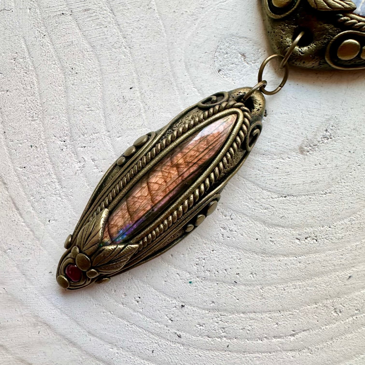 Handmade crystal necklace with a fossil Ammonite and colorful natural gemstone accents.