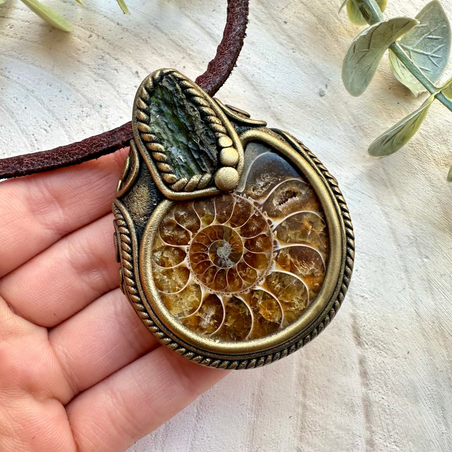 Handmade necklace with ammonite fossil and raw moldavite