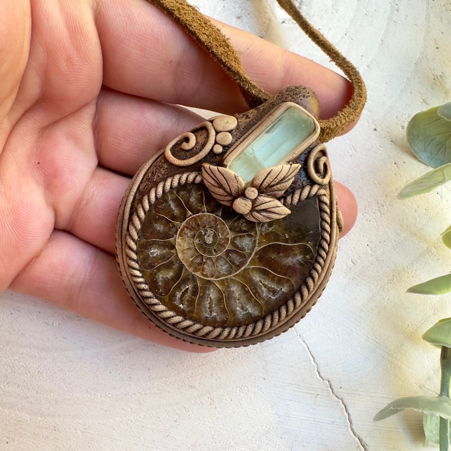 Unisex gemstone jewelry featuring ammonite fossil and aquamarine