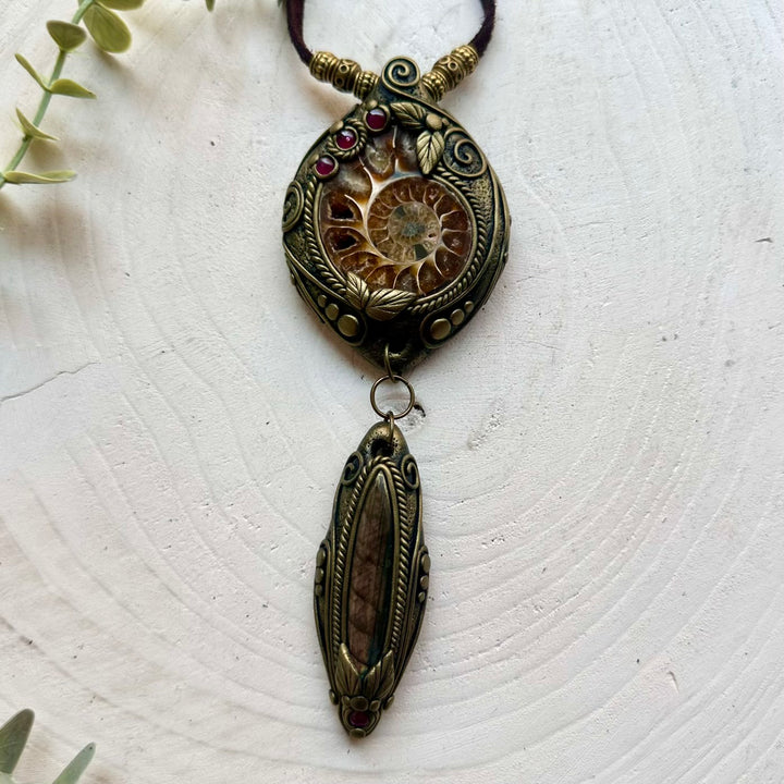 One of a kind crystal necklace handcrafted with Ammonite, Labradorite and Rhodolite Garnet.