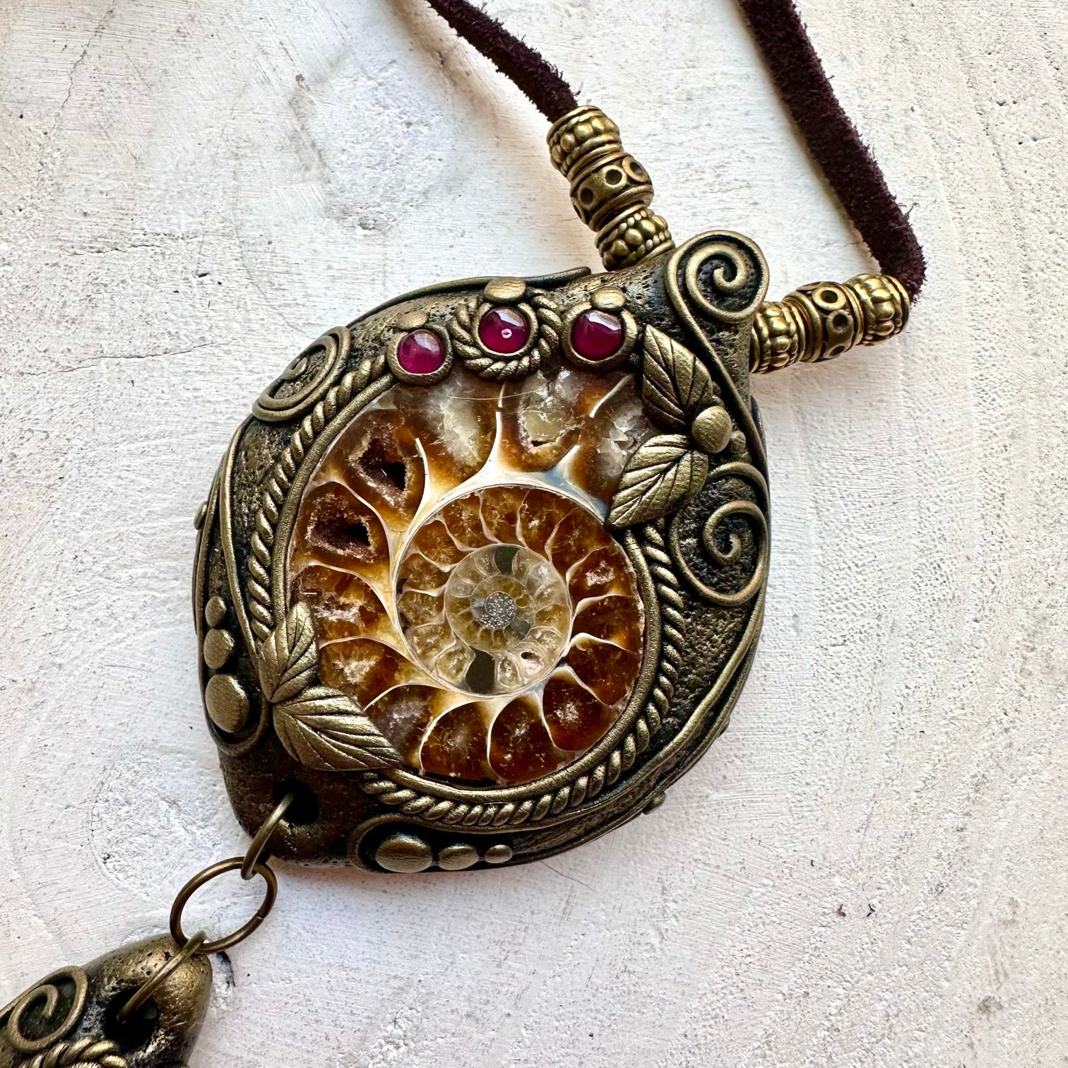 Elegant boho jewelry featuring Ammonite, Labradorite and Rhodolite Garnet in a handcrafted setting.