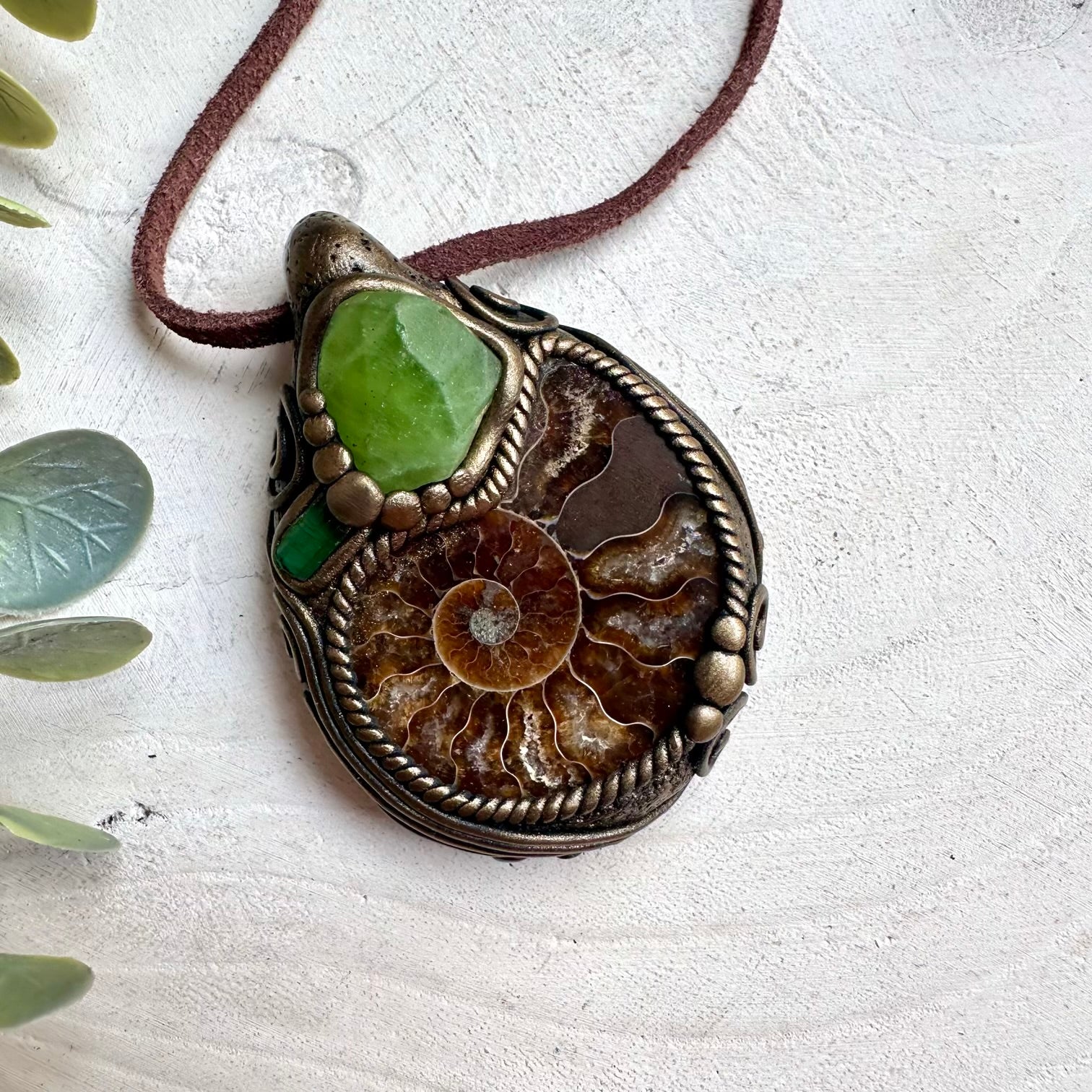 Ammonite necklace with peridot and green tourmaline healing crystals in spiritual jewelry style
