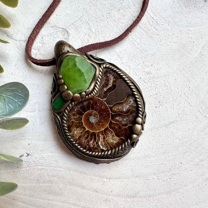 Ammonite necklace with peridot and green tourmaline healing crystals in spiritual jewelry style