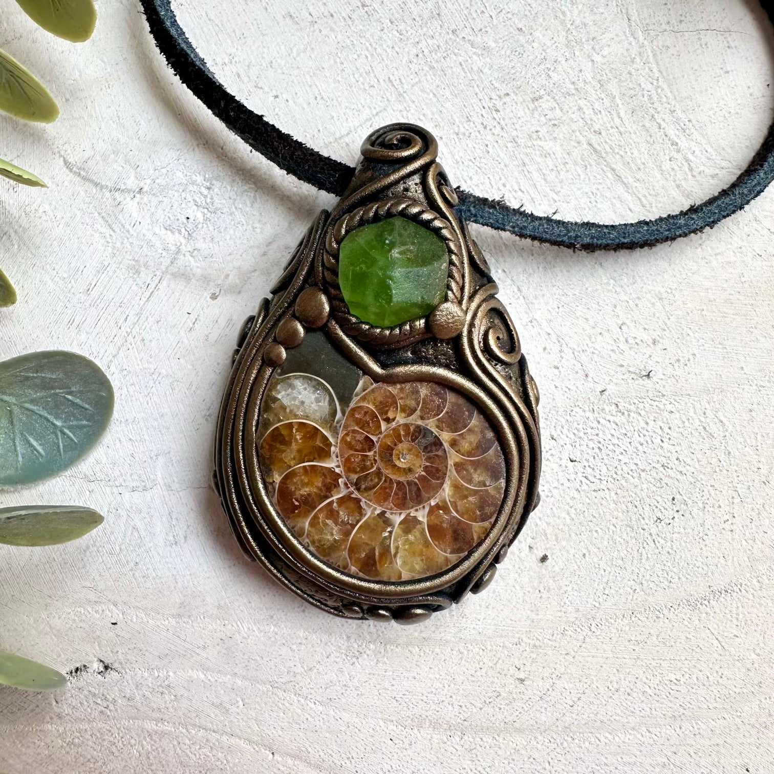 Raw ammonite fossil pendant necklace with peridot healing crystal accents and mystical jewelry