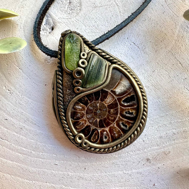Natural Ammonite pendant featuring a bright Peridot gemstone and a piece of Moldavite.
