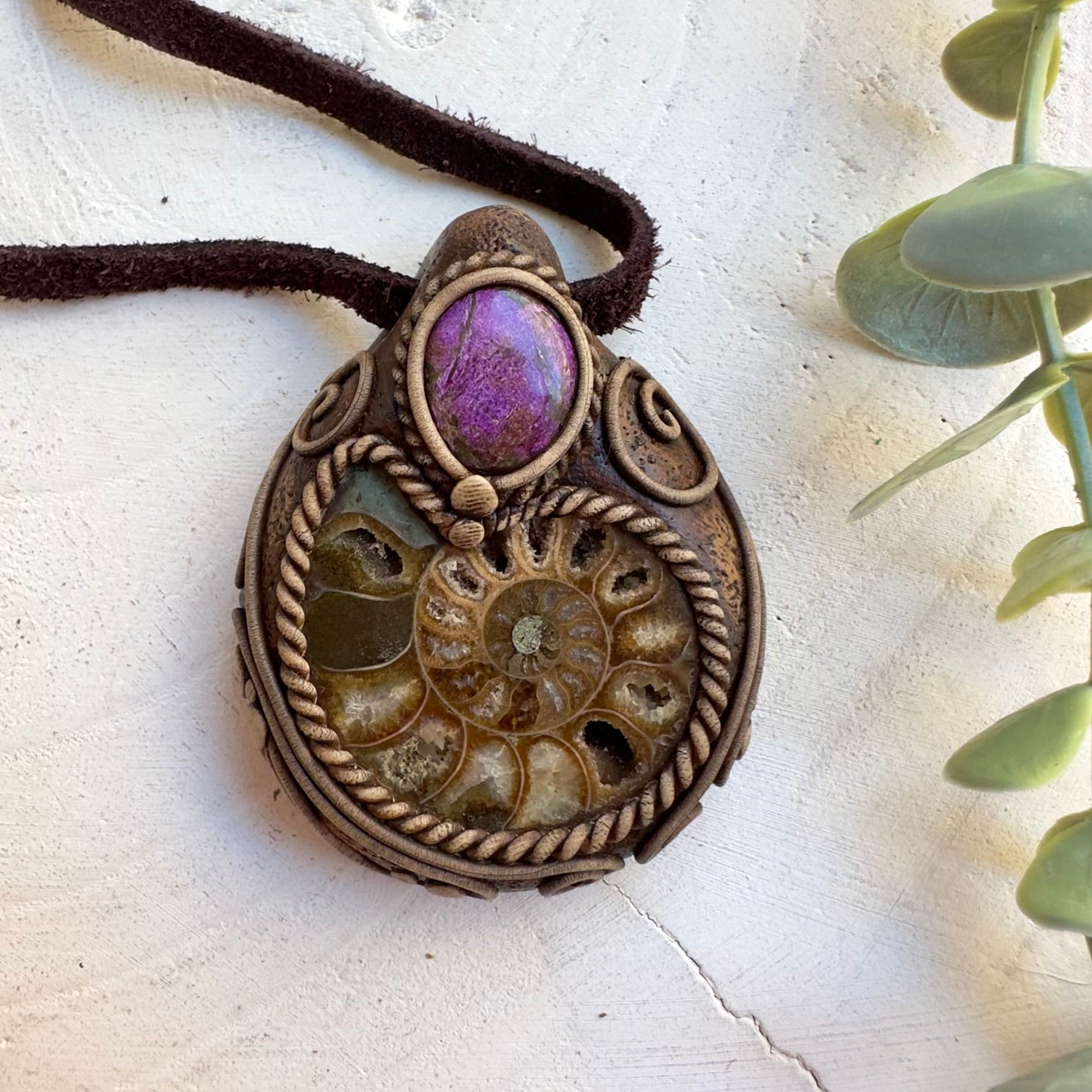 Protection amulet necklace featuring ammonite fossil and stichtite stone