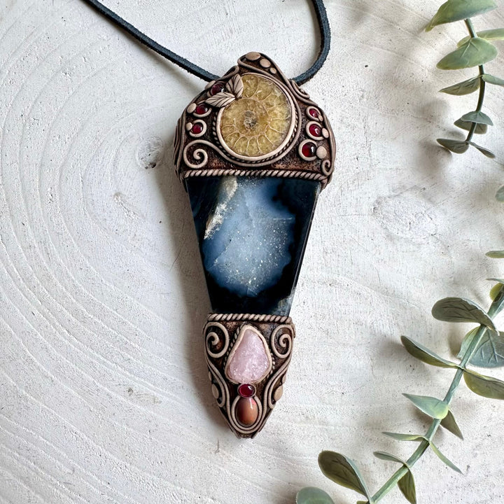 Natural Ammonite and Agate form the base of this unusual crystal wand pendant, accented with Morganite, Ethiopian Opal and Rhodolite Garnet.