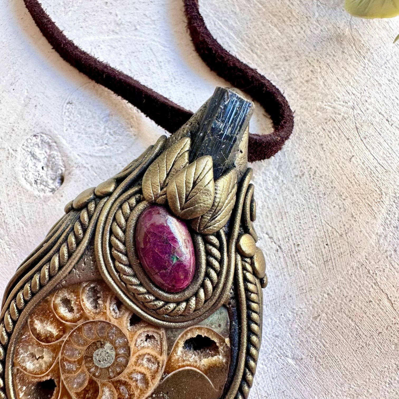 Handmade crystal jewelry with an Ammonite fossil, Black Tourmaline and Ruby accents.