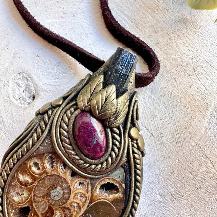 Handmade crystal jewelry with an Ammonite fossil, Black Tourmaline and Ruby accents.