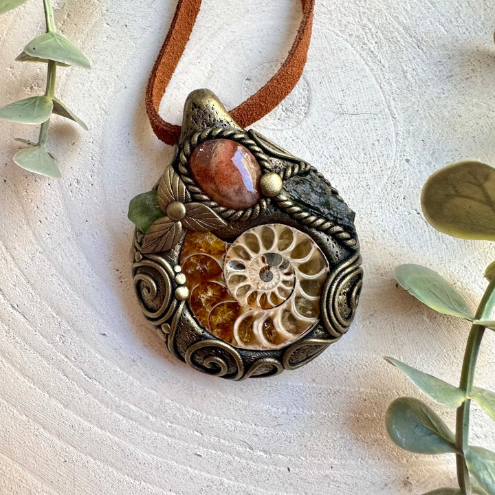 One of a kind handmade necklace featuring an ancient Ammonite fossil with warm and earthy gemstones.