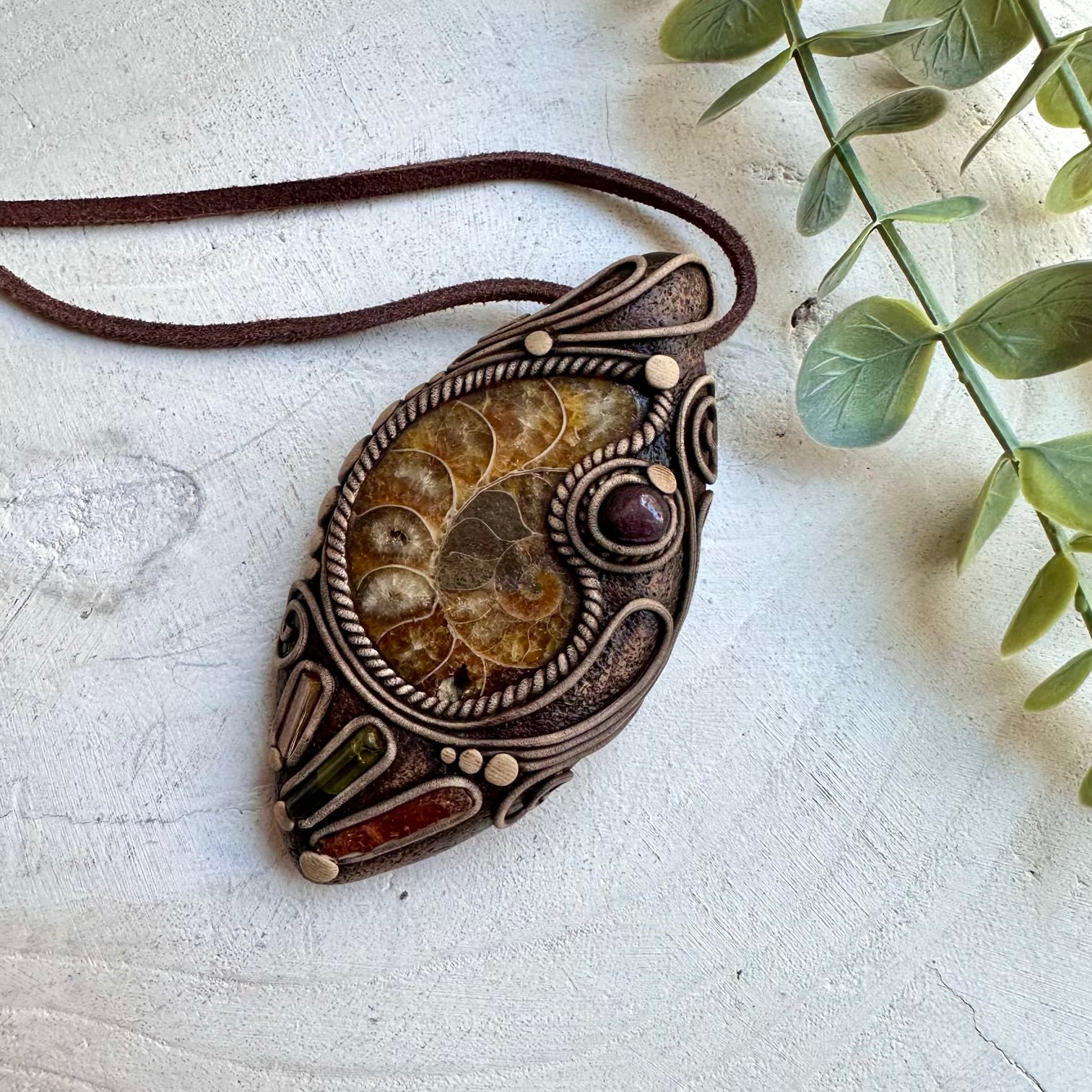 Ammonite paired with kyanite garnet green tourmaline and imperial topaz