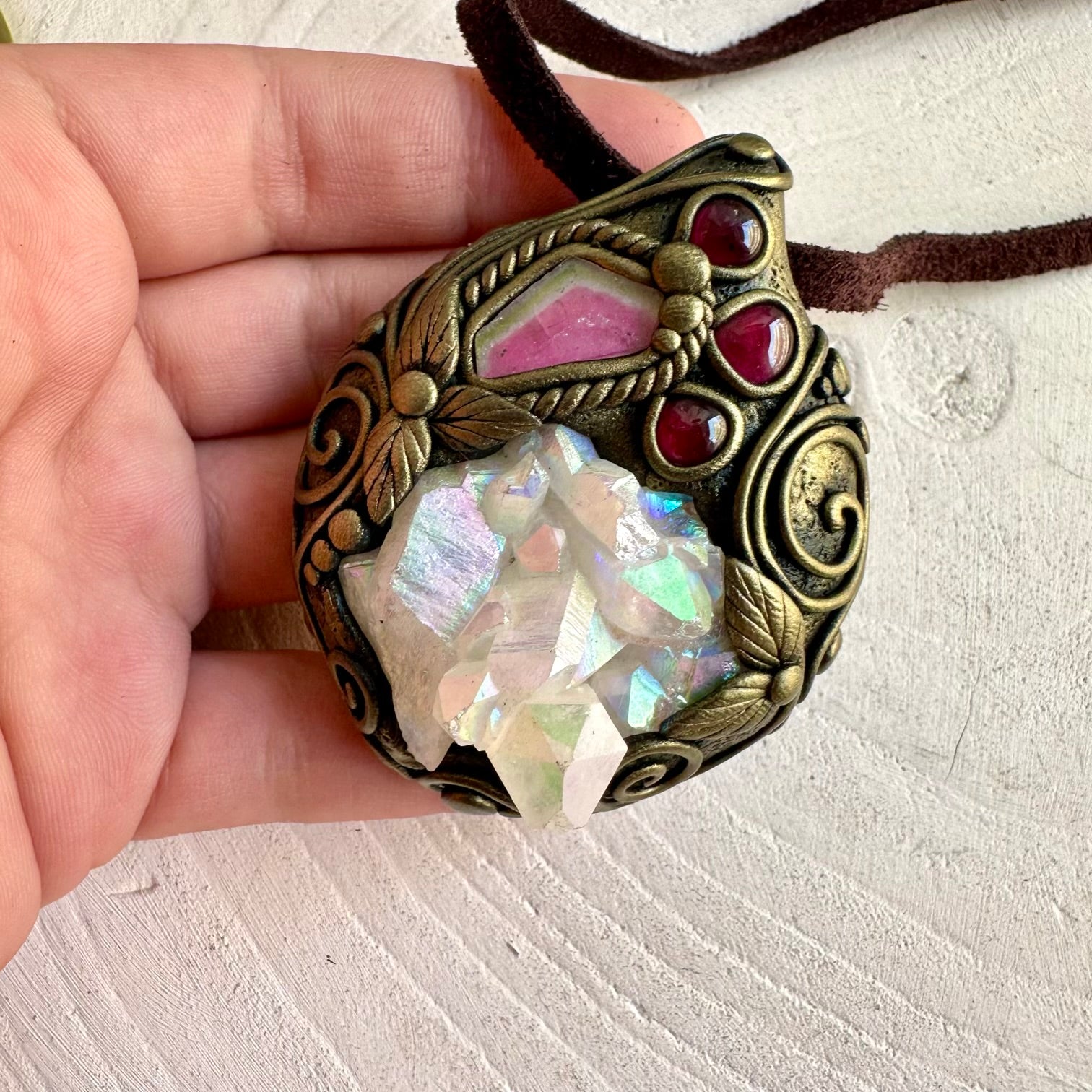 One of a kind crystal necklace featuring a shimmering Angel Aura Quartz Cluster with colorful gemstones.