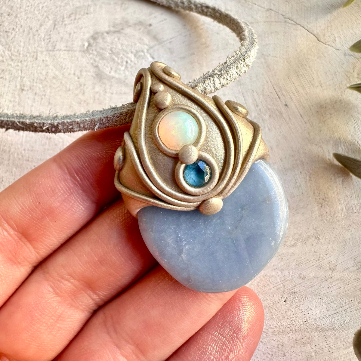 Artisan pendant featuring Angelite, deep blue London Blue Topaz and luminous Ethiopian Opal.