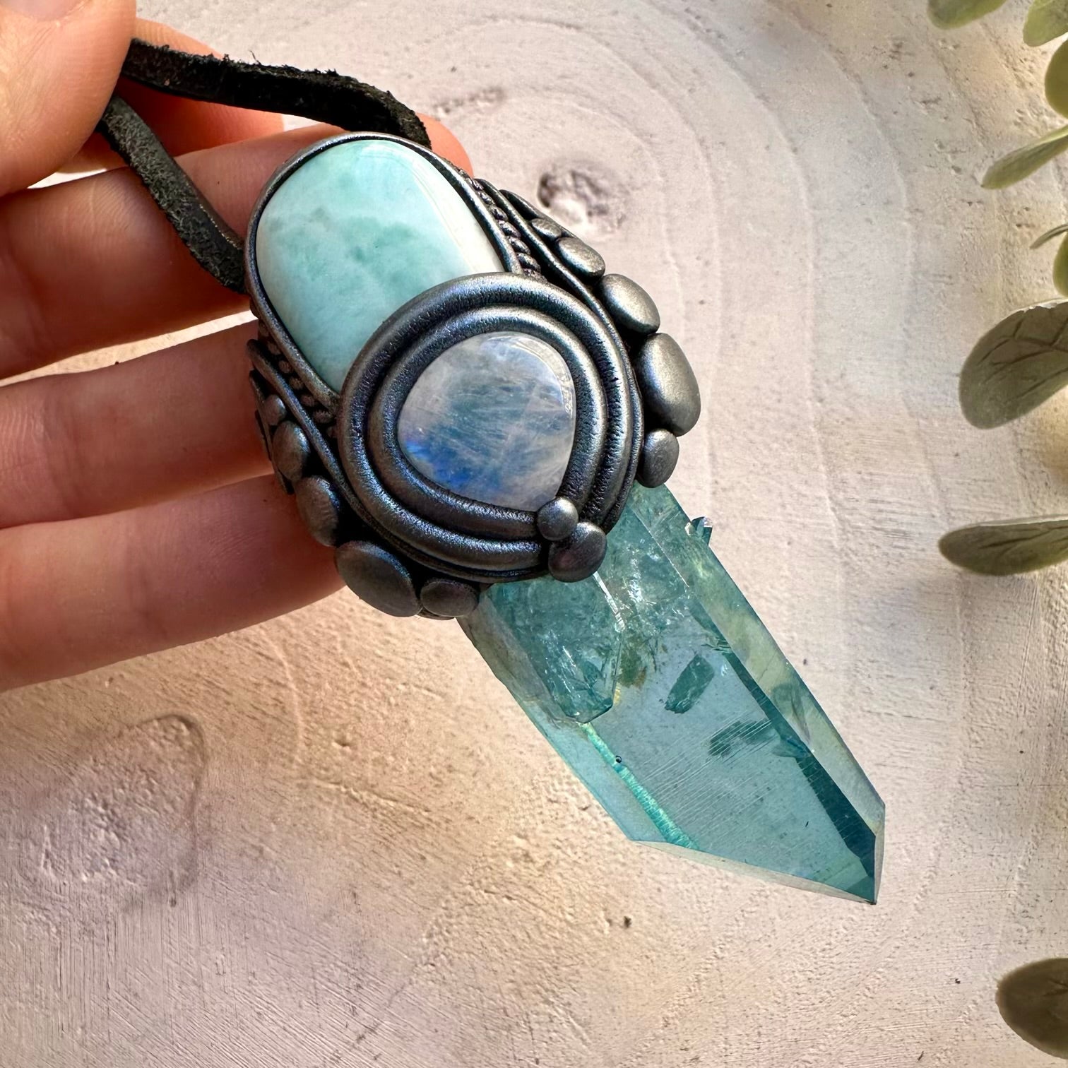Handmade spiritual necklace featuring aqua aura quartz and larimar