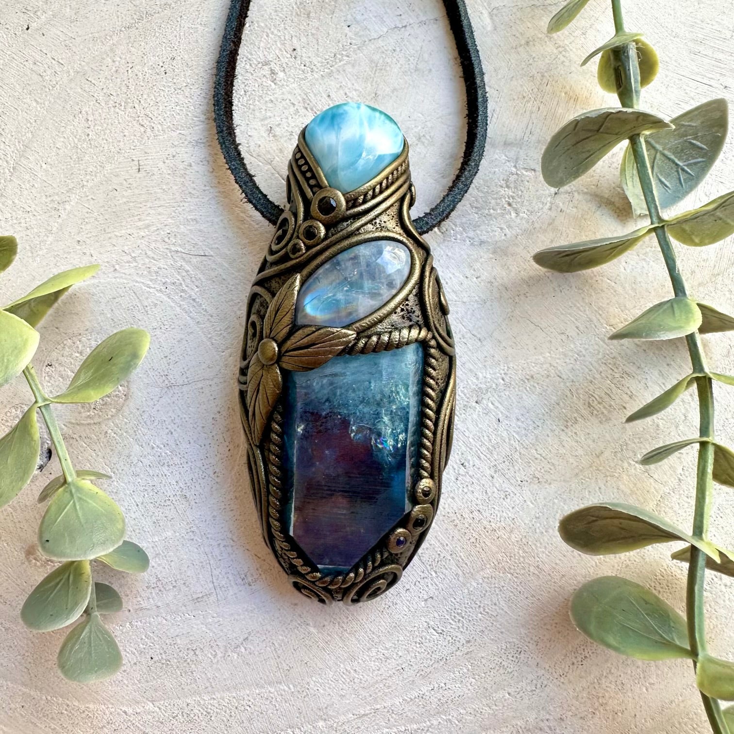 Handmade crystal jewelry featuring Larimar, Rainbow Moonstone and Blue Sapphire gemstones.