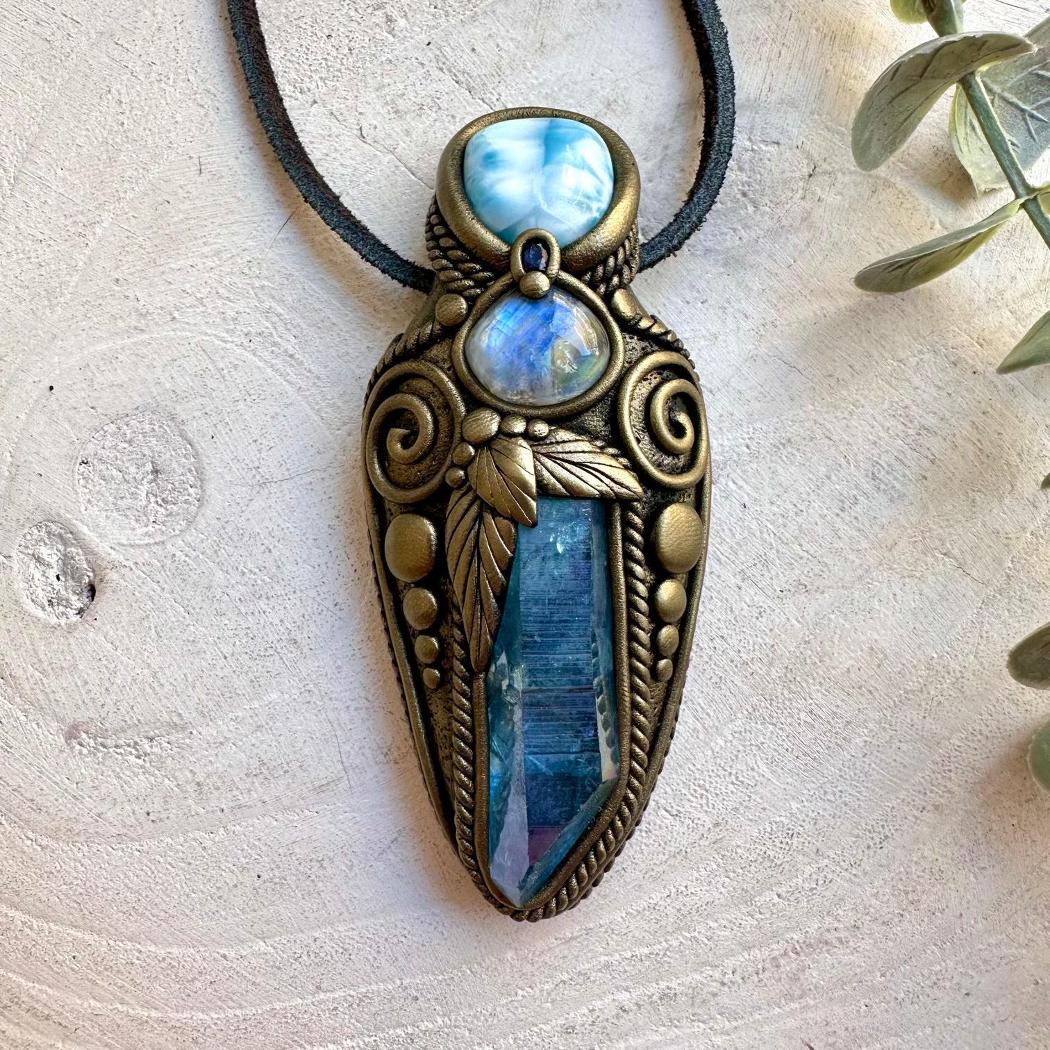 One of a kind crystal necklace featuring luminous Aqua Aura Quartz with soft blue Larimar.