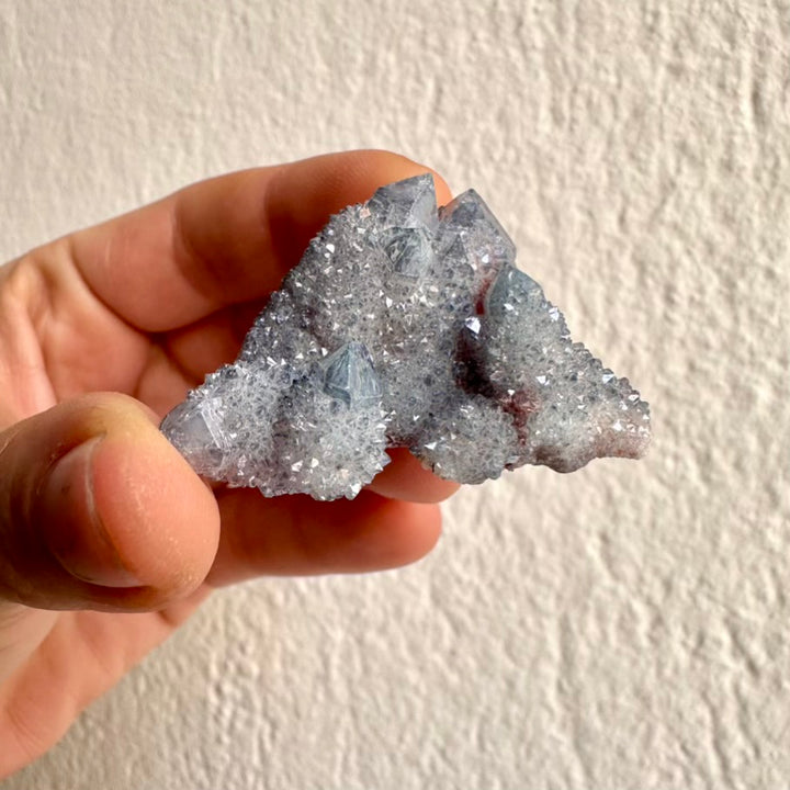 Raw Aqua Aura Quartz mineral with shimmering druzy crystals