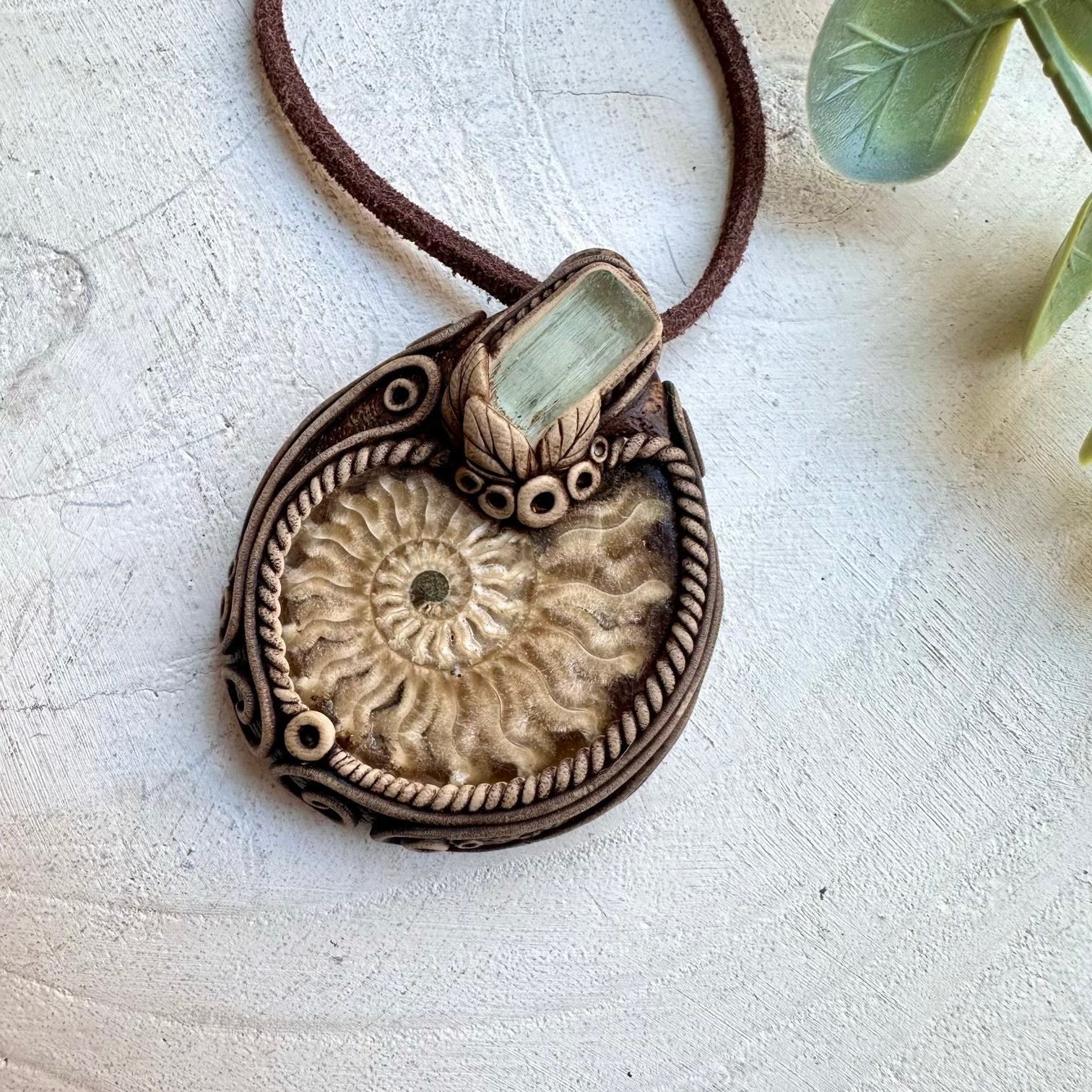 Ammonite paired with aquamarine in a necklace