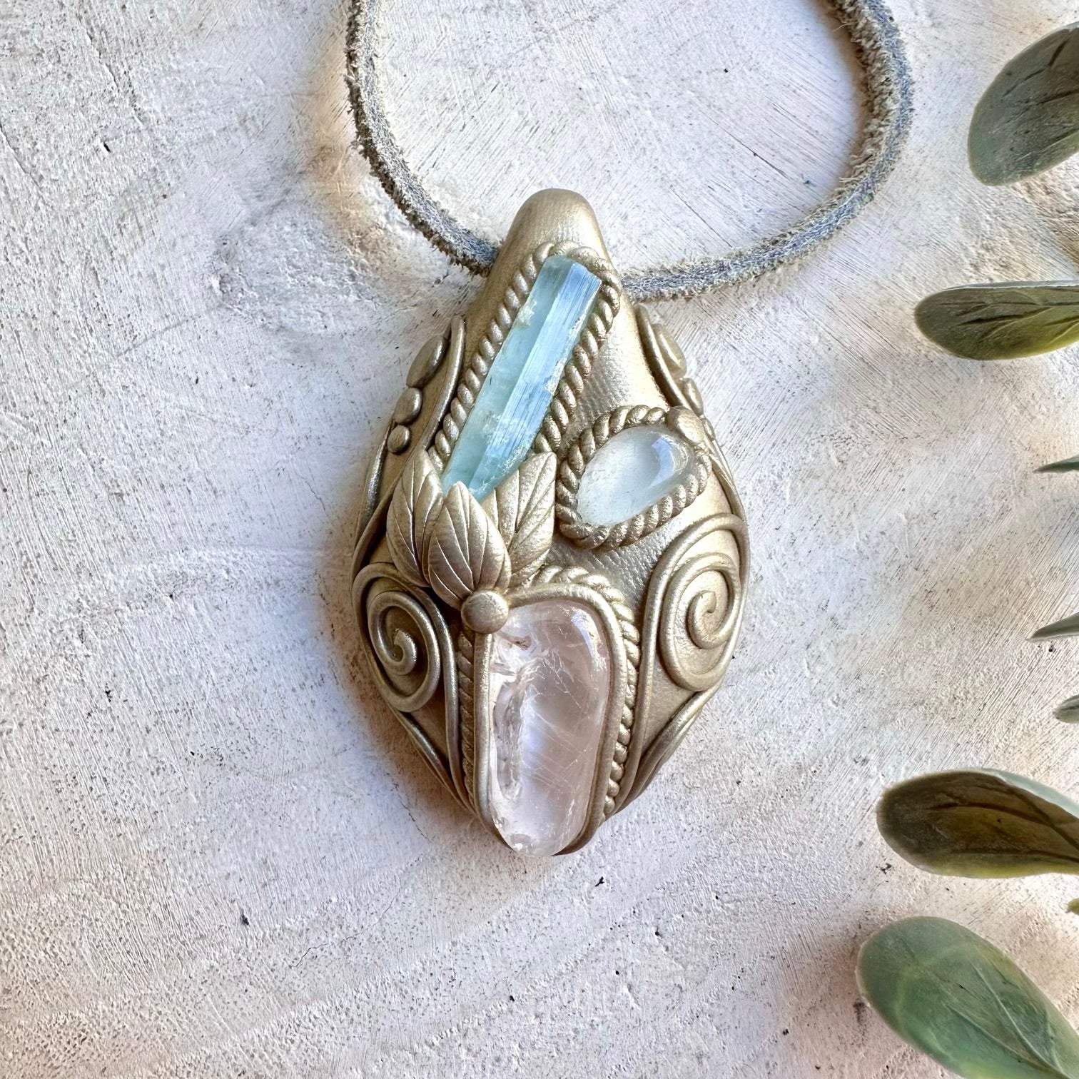 Unique pendant necklace featuring soft blue Aquamarine, luminous Danburite and clear Topaz.