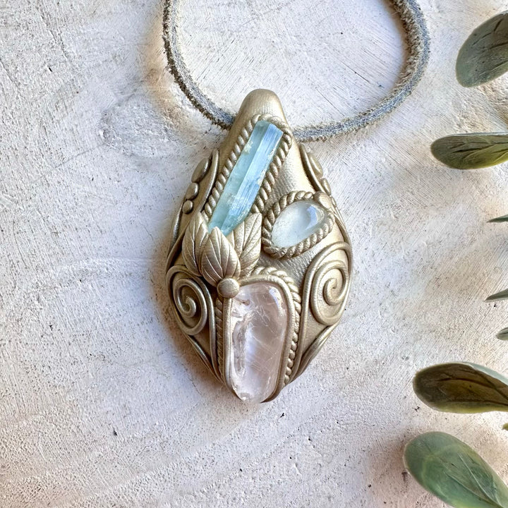 Unique pendant necklace featuring soft blue Aquamarine, luminous Danburite and clear Topaz.