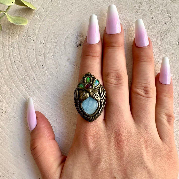 Natural gemstone jewelry with blue Aquamarine, vibrant Ethiopian Opal flashes and deep red Garnet.