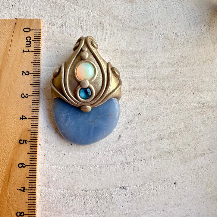 Soft blue Angelite gemstone paired with colorful Ethiopian Opal in a unique crystal necklace.