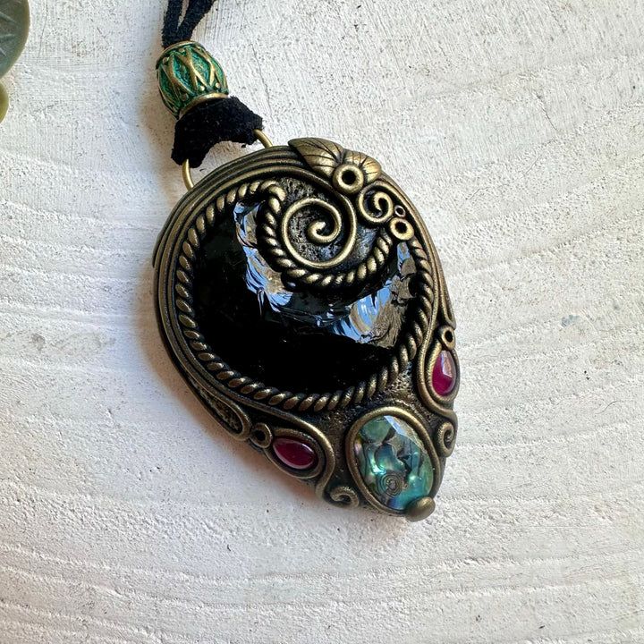 One of a kind spiritual necklace featuring a Black Obsidian Moon with shimmering Abalone Seashell.