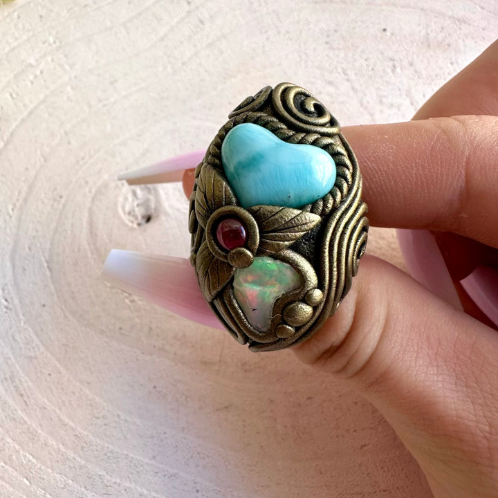 Handmade gemstone ring featuring a Larimar Heart, Raw Ethiopian Opal and Rhodolite Garnet.