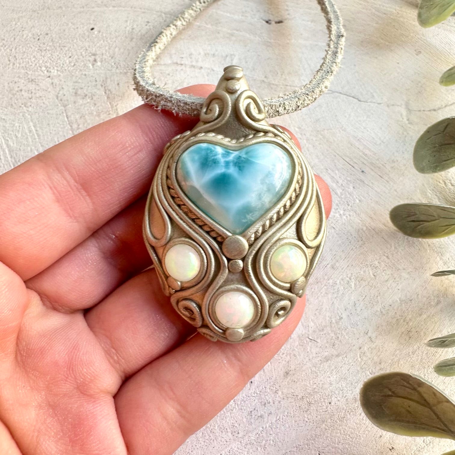 Handmade jewelry combining a heart-shaped Larimar gemstone with shimmering Ethiopian Opal.