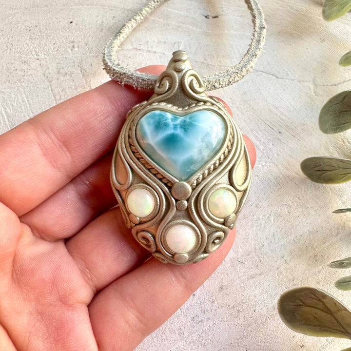 Handmade jewelry combining a heart-shaped Larimar gemstone with shimmering Ethiopian Opal.