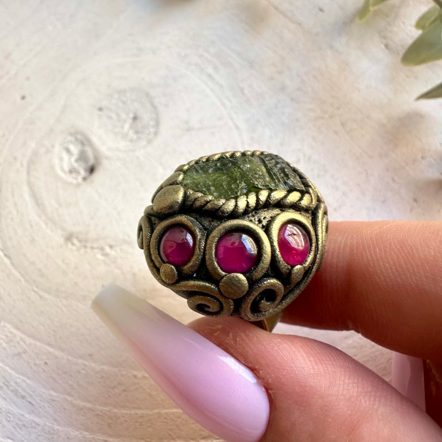 Adjustable crystal ring featuring natural Moldavite and Rhodolite Garnet in a unique handmade clay setting.