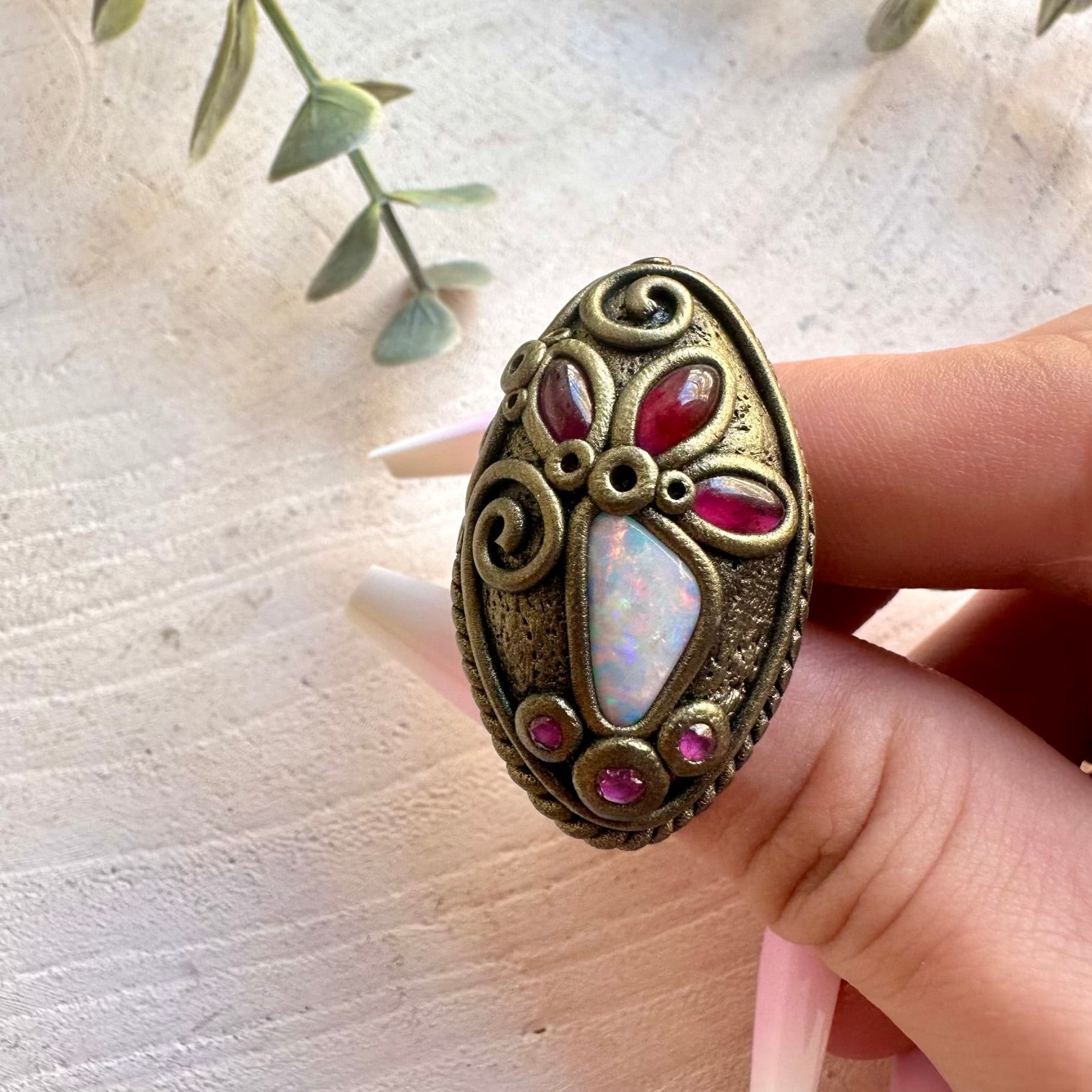 Handmade gemstone ring combining colorful Australian Opal with natural Garnet and Ruby.