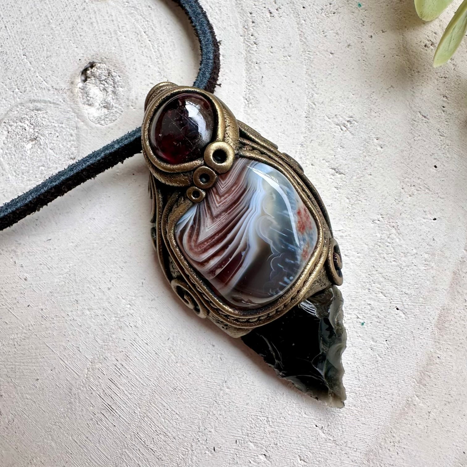 Black obsidian arrowhead with botswana agate and rhodolite garnet pendant necklace