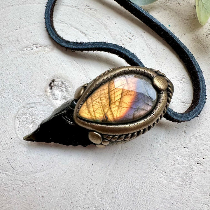 Obsidian arrowhead paired with labradorite in a necklace