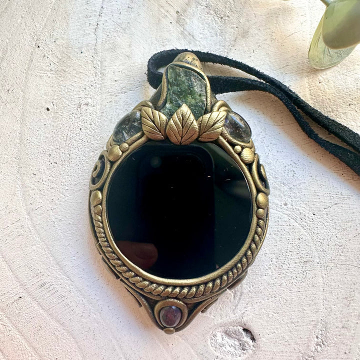 Handmade mystical crystal necklace featuring a Black Obsidian Mirror with Moldavite, Clear Topaz and Black Ethiopian Opal, a unique protection talisman designed for grounding, transformation, intuition and spiritual growth.