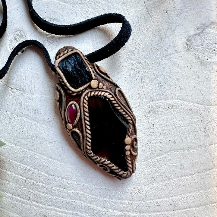 One of a kind crystal pendant handcrafted with Black Obsidian, Vivianite and Garnet gemstones.