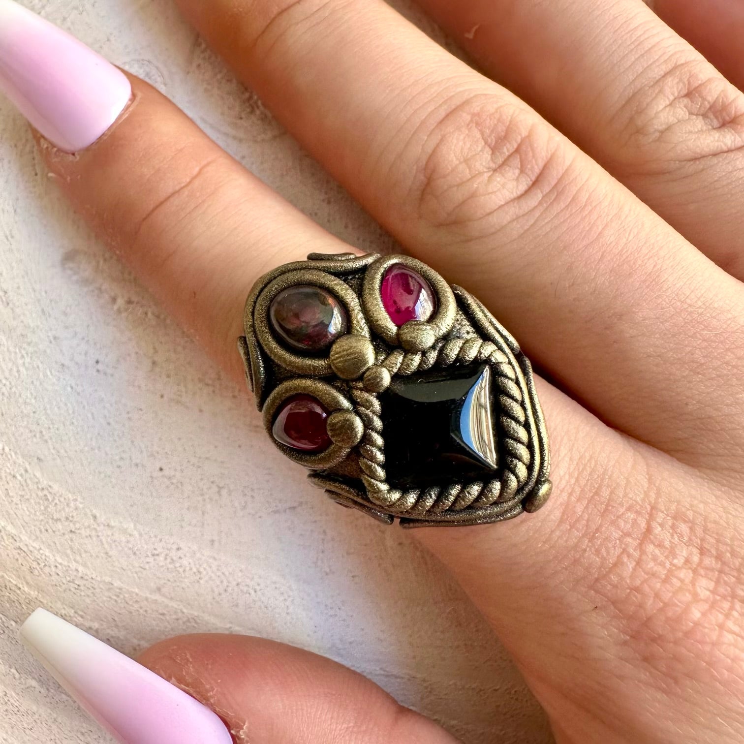 Handmade gemstone jewelry showcasing natural Black Onyx, Ethiopian Opal and rich red Garnet accents.