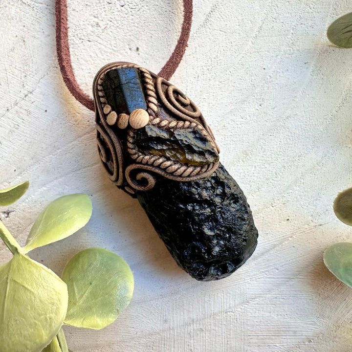 Natural black tektite paired with moldavite and tourmaline